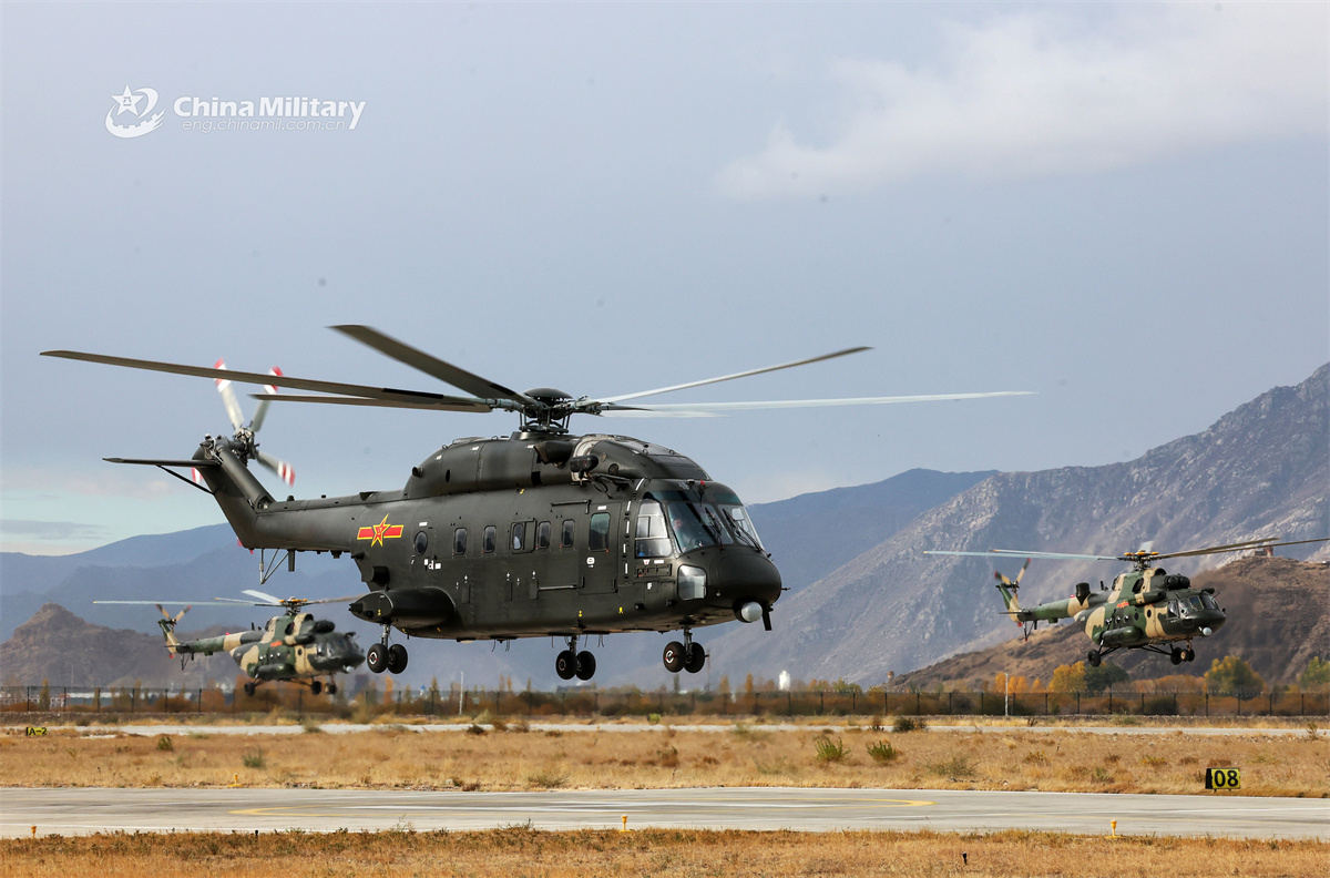 Multi-type helicopters fly over valley